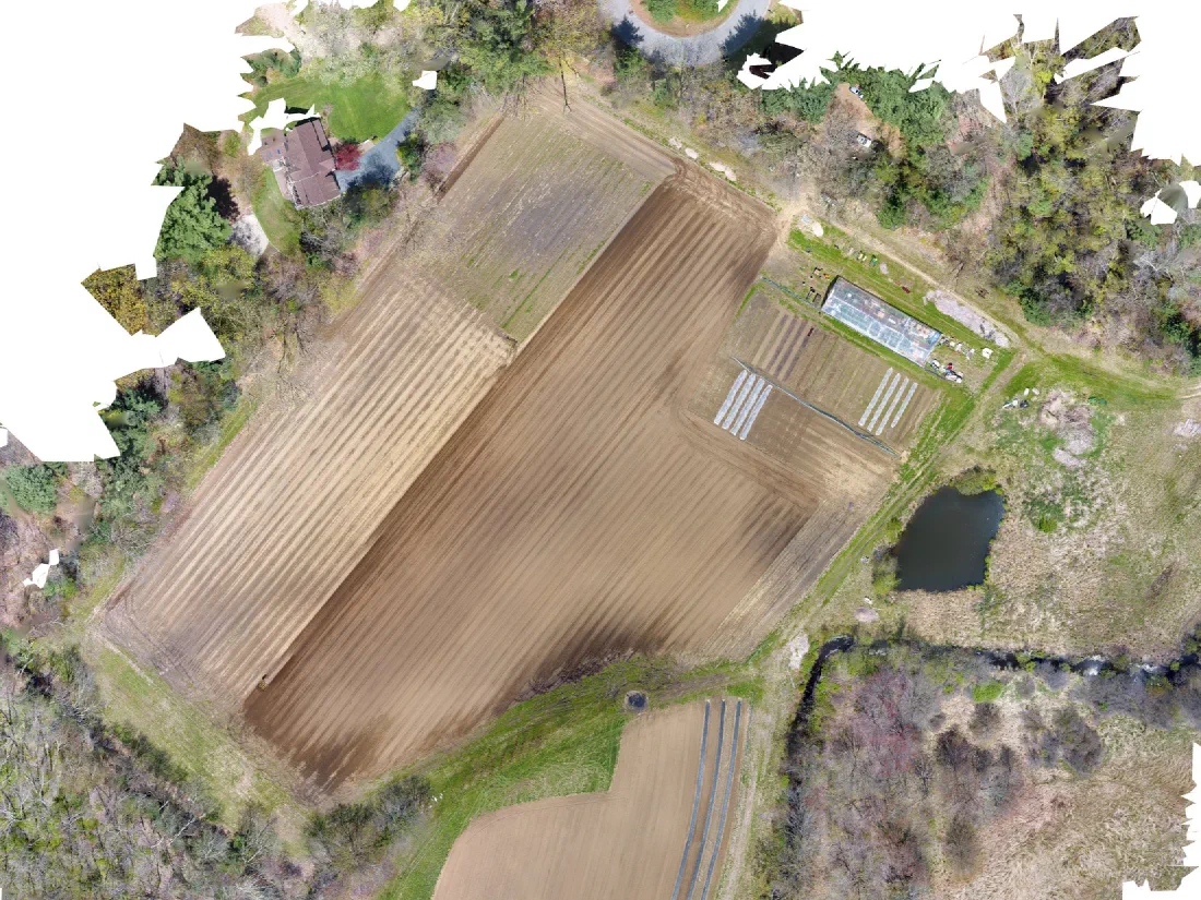 Orthomosaic of farm fields and greenhouses stitched from aerial capture